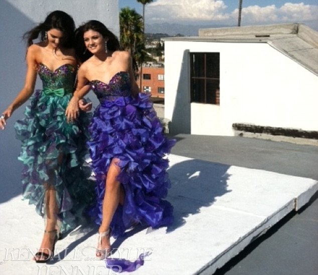 Dancing with the Jenners: Kendall (in green) and Kylie (in purple) looked ready to take to the dance floor in their birdlike prom dresses