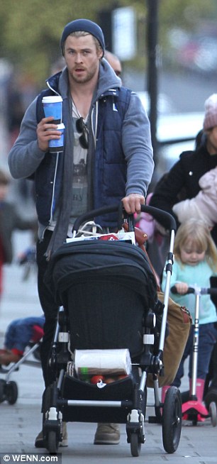 Multitasker: The actor showed off his impressive balancing and arm strength as he juggled two cups of coffee while pushing the pram