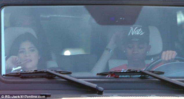 Concentrating: Kylie nibbled on her finger as they crawled along in the city